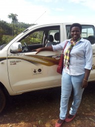 Vestine, Coordinator of AVEGA Western Region, with the vehicle for outreach and fieldwork procured with funding from Big Lottery Fund