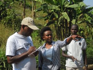 Alex Mugabo, SURF Programme Manager, with AVEGA team, looking at agricultural income generation groups in the context of DFID support for widows in Western Province.
