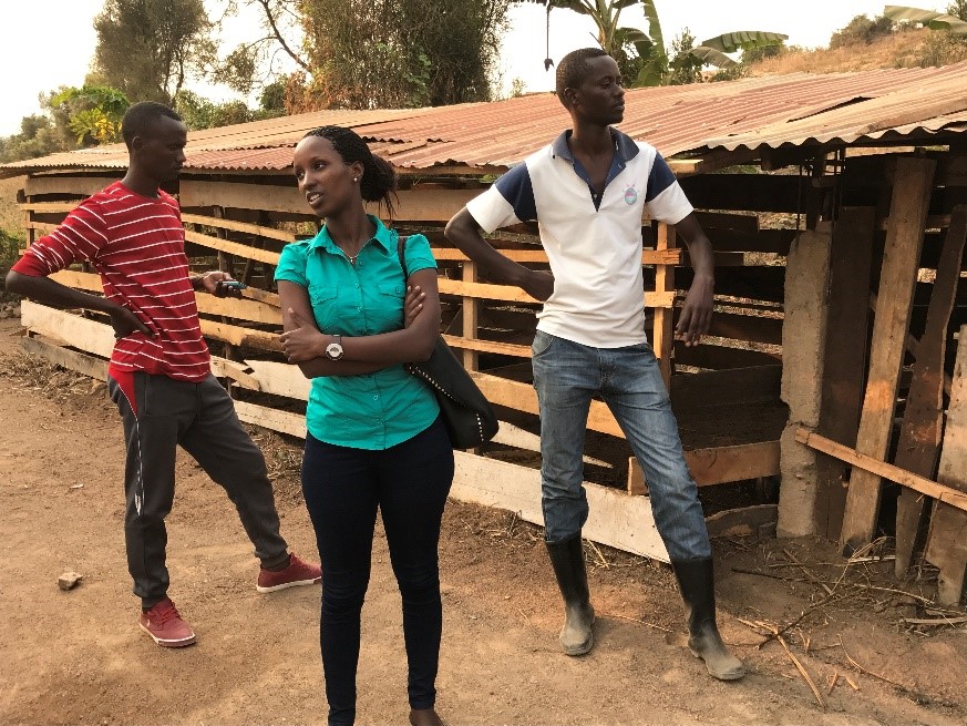 Kevine (centre) with two of her employees at the pig farm she has established