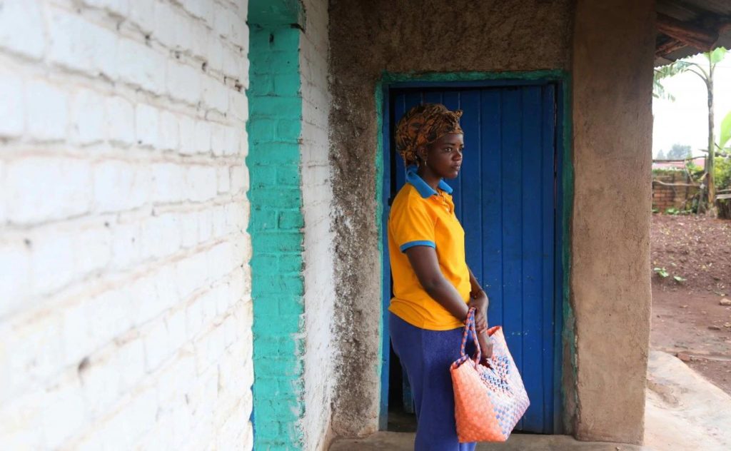 Angel stands in front of the house she shares with her mother in Rwanda's Ngoma sector on Feb. 26. Tourism is her dream career. Her backup plan is selling tomatoes (Whitney Shefte, Washington Post)
