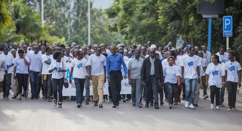 President Paul Kagame (middle) joins members of AERG and GAERG in Kigali for the Walk to Remember. Mourners head to Amahoro national stadium and proceed with a night vigil in 2018.