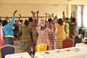 Women survivors dancing together at the 2017 retreat