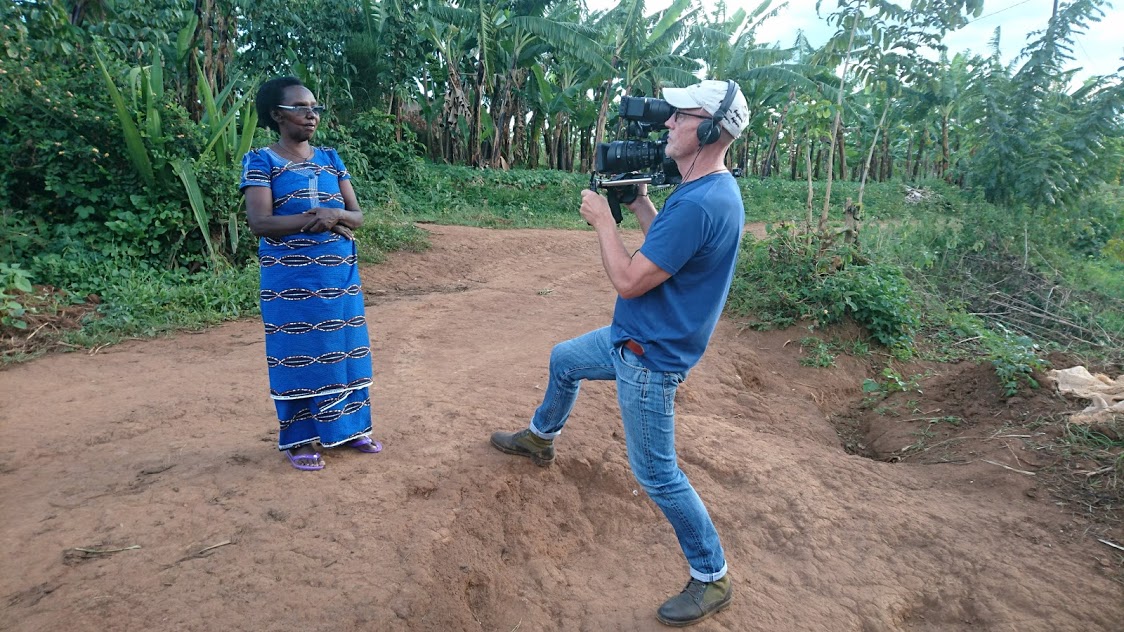 Andrew Sutton filming an interview with Daphrose outside her home in the Eastern Province, Rwanda
