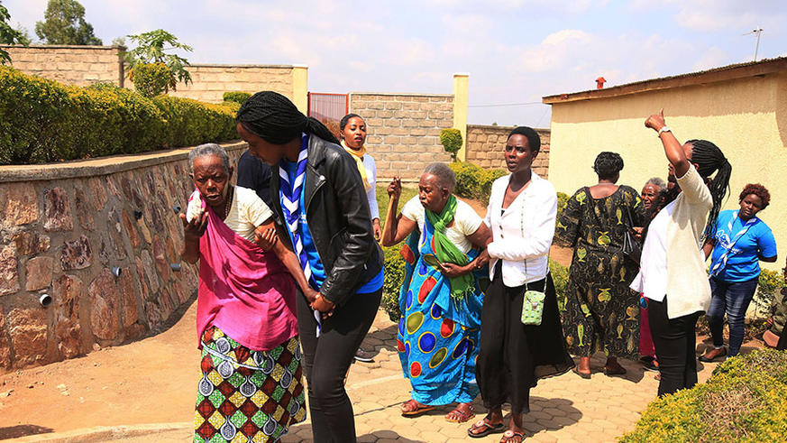 Members of AERG help elderly genocide survivors in Nyanza District